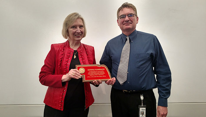 photograph of Ed Toner presenting award to Donna Hammack
